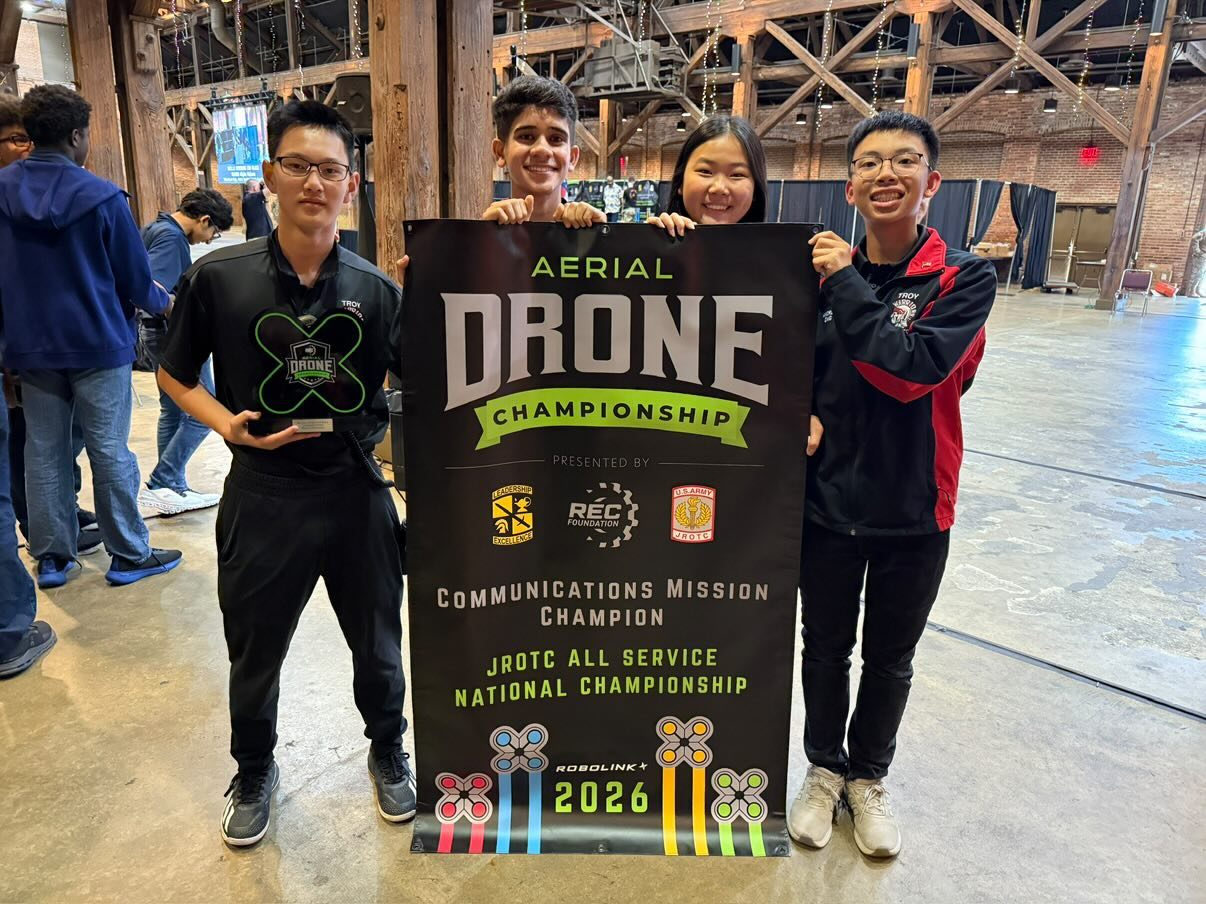 Andrew Ong and his team holding the Communications Mission Champion banner